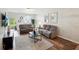 Inviting living room featuring wood flooring, modern furniture, decor, and lots of light at 30352 Elderwood Dr, Wesley Chapel, FL 33543