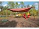 Covered playground with slides and climbing features set on mulch ground at 30352 Elderwood Dr, Wesley Chapel, FL 33543