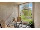 Screened patio with chairs overlooking the backyard at 30352 Elderwood Dr, Wesley Chapel, FL 33543