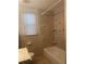 Bright bathroom featuring tiled walls, bathtub, and a window for natural light at 3110 58Th N Ave, St Petersburg, FL 33714
