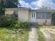 A single Gathering home with a white front door and small front yard at 3110 58Th N Ave, St Petersburg, FL 33714