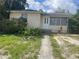 A single Gathering home with a white front door and small front yard at 3110 58Th N Ave, St Petersburg, FL 33714