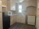 Functional kitchen featuring white cabinets, appliances, and ample countertop space at 3110 58Th N Ave, St Petersburg, FL 33714