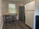 Bright kitchen nook with a cozy table and chairs, next to white refrigerator and cabinet at 3110 58Th N Ave, St Petersburg, FL 33714