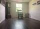 Living room featuring hardwood floors, vintage grandfather clock, and a cozy rocking chair at 3110 58Th N Ave, St Petersburg, FL 33714