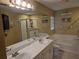 Bright bathroom featuring double sinks, a bathtub and a glass door shower at 31141 Harthorn Ct, Wesley Chapel, FL 33543