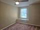 This bedroom has a ceiling fan and a window with a window seat beneath it at 31141 Harthorn Ct, Wesley Chapel, FL 33543