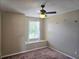 This bedroom includes a ceiling fan and a window seat beneath the window at 31141 Harthorn Ct, Wesley Chapel, FL 33543
