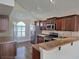 Modern kitchen featuring stainless steel appliances, dark cabinets, granite countertops, and recessed lighting at 31141 Harthorn Ct, Wesley Chapel, FL 33543