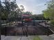 A fenced playground with swings and slides, perfect for Gathering fun and outdoor activities at 31141 Harthorn Ct, Wesley Chapel, FL 33543