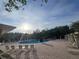 A community swimming pool with lounge chairs and patio furniture around it at 31141 Harthorn Ct, Wesley Chapel, FL 33543