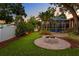 Features fire pit, screened-in pool, putting green, and beautifully landscaped backyard at 3307 W Knights Ave, Tampa, FL 33611