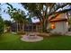 Aerial backyard view with a firepit, putting green, and screened-in pool at 3307 W Knights Ave, Tampa, FL 33611