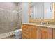 Bathroom features a glass-enclosed shower and wooden vanity with granite countertop at 3307 W Knights Ave, Tampa, FL 33611