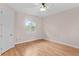 Bright bedroom with hardwood floors, plantation shutters, and a ceiling fan at 3307 W Knights Ave, Tampa, FL 33611