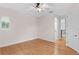 Spacious bedroom with hardwood floors, ceiling fan, and an arched window at 3307 W Knights Ave, Tampa, FL 33611
