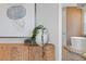 Bedroom featuring art, a leafy plant and a view to the bathroom and tub at 3307 W Knights Ave, Tampa, FL 33611