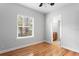 Bedroom features hardwood floors, a window with blinds, and an ensuite bathroom at 3307 W Knights Ave, Tampa, FL 33611