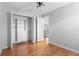 Bedroom featuring hardwood floors, a walk-in closet, and access to the hallway at 3307 W Knights Ave, Tampa, FL 33611