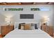 Bedroom with wood beam ceilings, side tables with lamps and two windows allowing natural light at 3307 W Knights Ave, Tampa, FL 33611