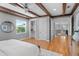 Bedroom featuring wood beam ceilings, hardwood floors, and an open closet space at 3307 W Knights Ave, Tampa, FL 33611