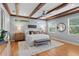 Spacious bedroom with wood beam ceilings, hardwood floors, and many windows allowing natural light at 3307 W Knights Ave, Tampa, FL 33611