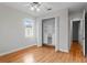 Bedroom showcasing hardwood floors, closet with built-in shelving, and a window at 3307 W Knights Ave, Tampa, FL 33611