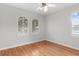 Bright bedroom featuring hardwood floors, arched windows, and plantation shutters at 3307 W Knights Ave, Tampa, FL 33611