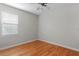 Bedroom featuring hardwood floors, a ceiling fan, and a bright window at 3307 W Knights Ave, Tampa, FL 33611