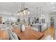 Spacious dining area with an open floor plan, modern lighting, hardwood floors, and views of the kitchen at 3307 W Knights Ave, Tampa, FL 33611