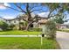 Inviting two-story home with lush landscaping, brick paver driveway, and charming curb appeal at 3307 W Knights Ave, Tampa, FL 33611