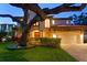 Stunning two-story home boasts lush landscaping, an arched garage, a tile roof and a brick paved driveway at 3307 W Knights Ave, Tampa, FL 33611
