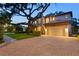 Stunning two-story home with a red tile roof, two-car garage and brick paver driveway at 3307 W Knights Ave, Tampa, FL 33611