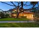 Two-story home with a tile roof, large tree, and well-manicured lawn at 3307 W Knights Ave, Tampa, FL 33611