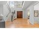 Open foyer featuring wood floors, staircase with wrought iron railing and lots of natural light at 3307 W Knights Ave, Tampa, FL 33611