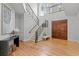 Bright foyer with grand staircase, wood floors, iron railings, and a dramatic chandelier at 3307 W Knights Ave, Tampa, FL 33611