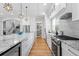 This open kitchen has a large island with granite countertop and stainless steel appliances at 3307 W Knights Ave, Tampa, FL 33611