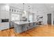Modern kitchen with a large island, stainless steel appliances, granite countertops, and pendant lighting at 3307 W Knights Ave, Tampa, FL 33611