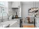 This modern kitchen features a granite countertop, stainless steel appliances, and a view to the dining room at 3307 W Knights Ave, Tampa, FL 33611