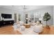 Bright living room featuring hardwood floors, stylish decor, and a cozy seating area with lots of light from the window at 3307 W Knights Ave, Tampa, FL 33611