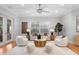 Inviting living room featuring modern furniture, a large window, and a ceiling fan for added comfort at 3307 W Knights Ave, Tampa, FL 33611