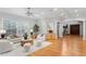 Spacious living room with hardwood floors, modern furniture, and an open layout leading to other rooms at 3307 W Knights Ave, Tampa, FL 33611