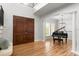 Bright living room with wood floors, large wood doors, and a Yamaha grand piano at 3307 W Knights Ave, Tampa, FL 33611