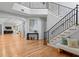 Spacious open-concept living room with wood floors, staircase and stylish décor at 3307 W Knights Ave, Tampa, FL 33611