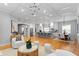 Open-concept living space with kitchen, dining area, and a living room featuring hardwood floors at 3307 W Knights Ave, Tampa, FL 33611