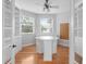 Bright office space featuring hardwood floors, built-in shelving, and natural light from two windows at 3307 W Knights Ave, Tampa, FL 33611