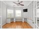 Bright home office featuring custom built-in shelves, a large desk, and hardwood floors at 3307 W Knights Ave, Tampa, FL 33611