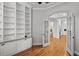 Bright office featuring hardwood floors, built-in shelving, and open access to other areas in the home at 3307 W Knights Ave, Tampa, FL 33611