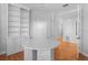 Home office featuring built-in shelving, hardwood floors, and natural light at 3307 W Knights Ave, Tampa, FL 33611