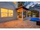 Covered patio area overlooking the bright blue pool with screened-in lanai at 3307 W Knights Ave, Tampa, FL 33611